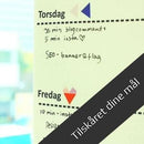 Hvid whiteboardfolie med ugedagsplan. Tekst i farver. Banner: "Tilskåret dine mål".